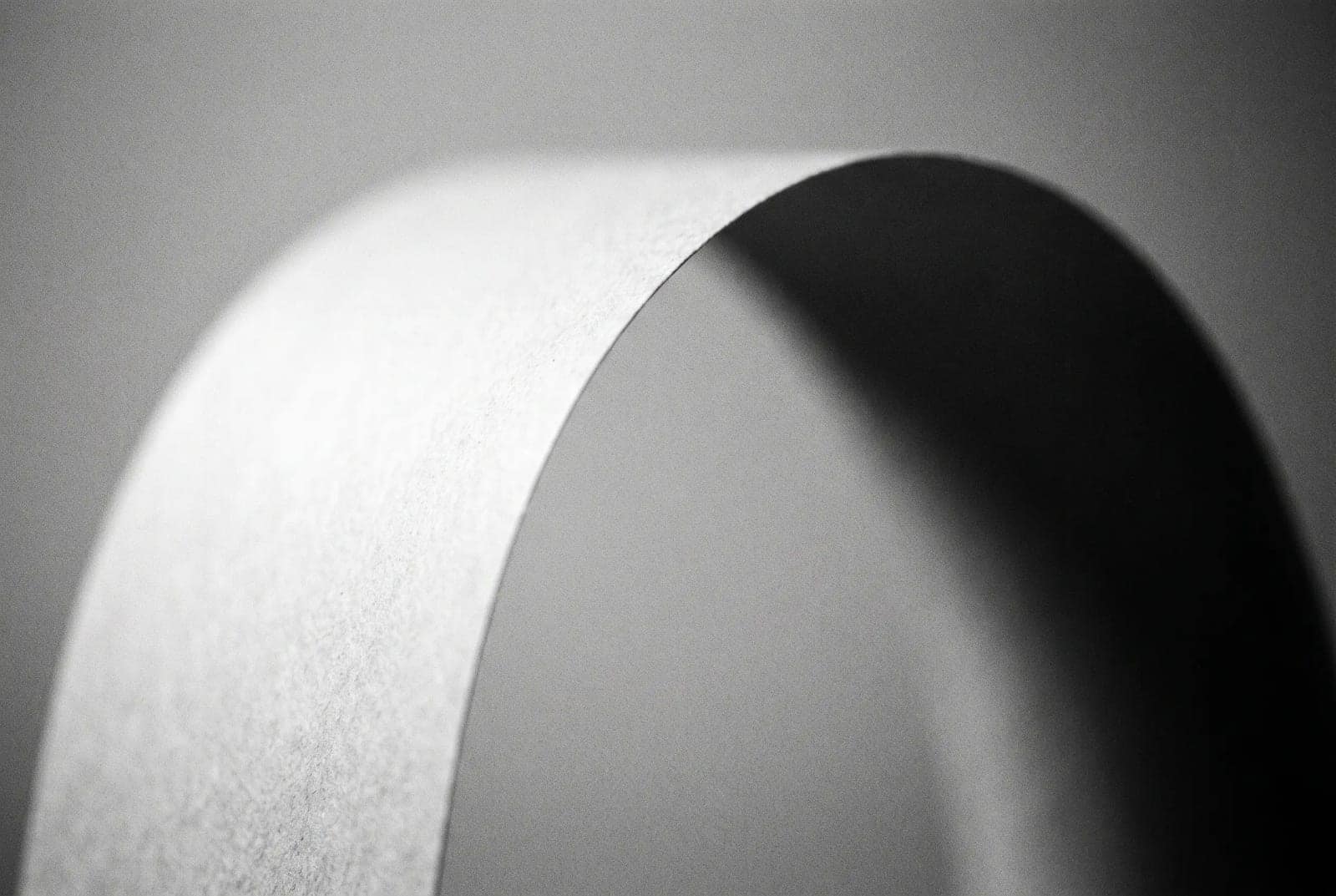 Minimal Monochrome Form, One soft curve of light against a field of black, and nothing else