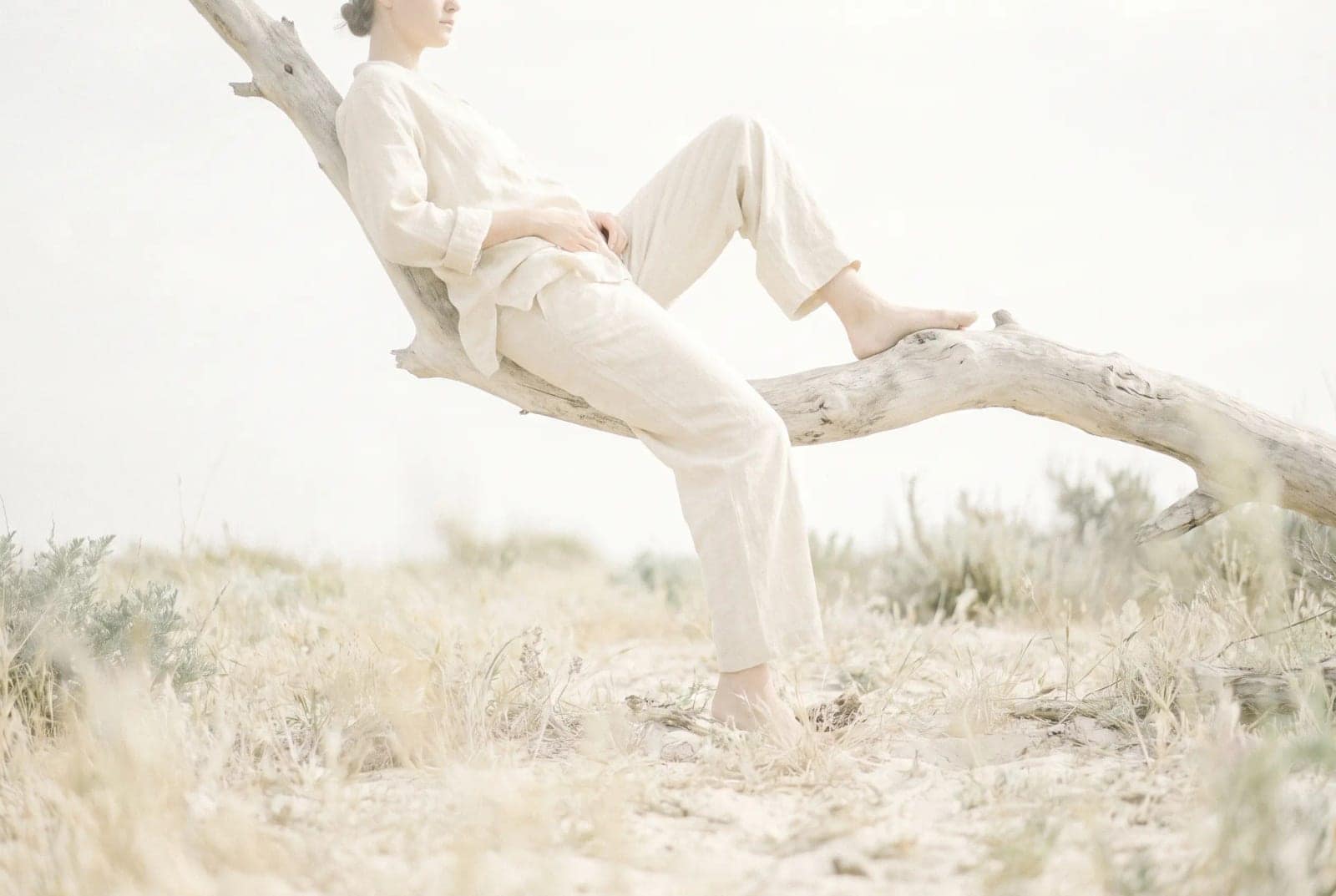 Pale Dream Photo, A figure resting in a bleached out landscape of almost no colour